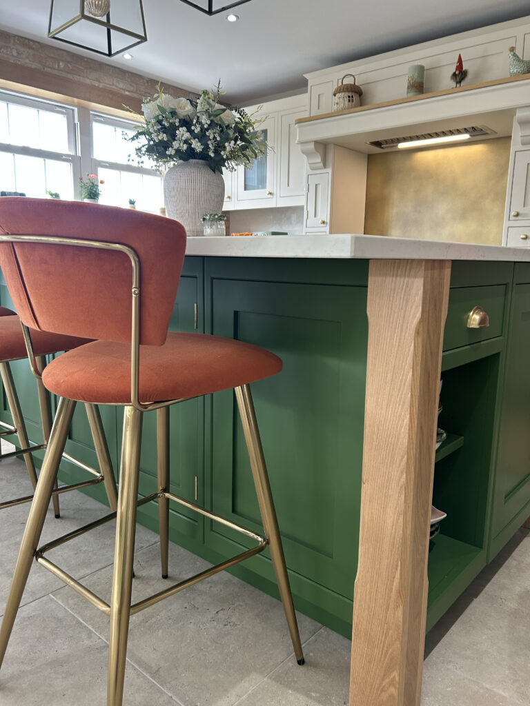 Kitchen renovation with new island and brass splashback.